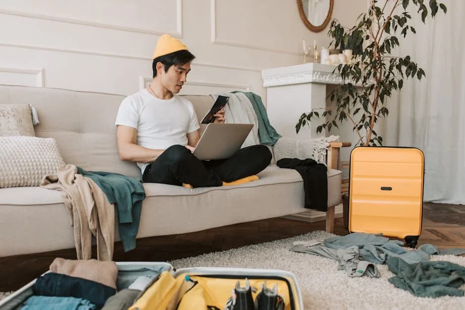 American traveler planning India trip with map and laptop