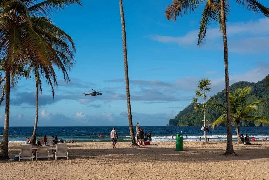 Caribbean island police officer patrolling a tourist area with a beach in the background